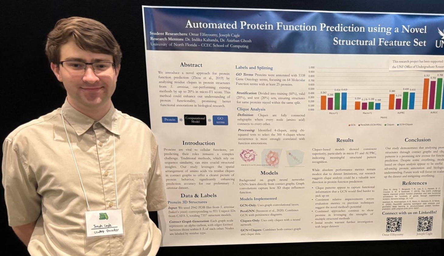 Joseph Cagle standing in front of his research poster.