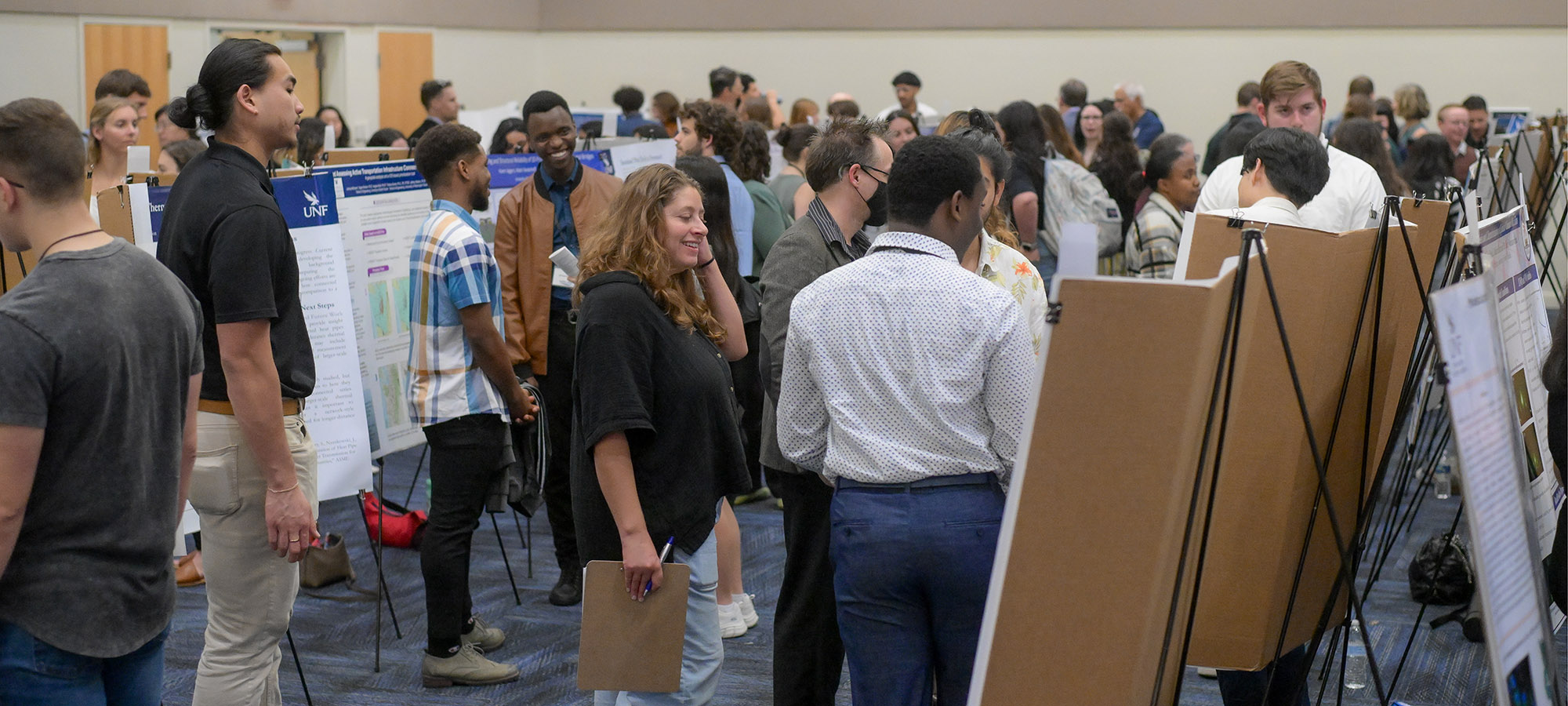 crowd of people at the student research symposium