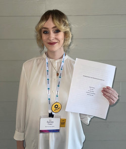 sydney holding her thesis