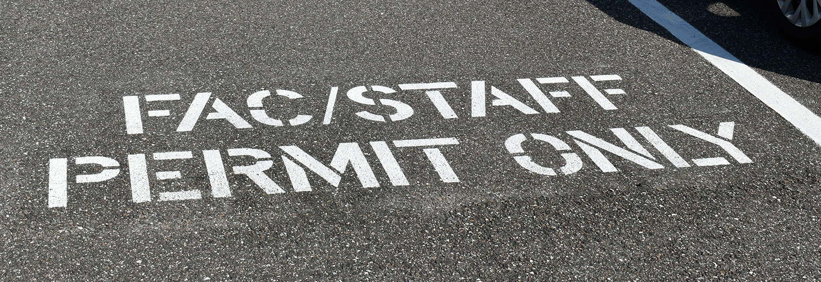 Faculty and Staff Permit Only stenciled on a parking space in Lot 3