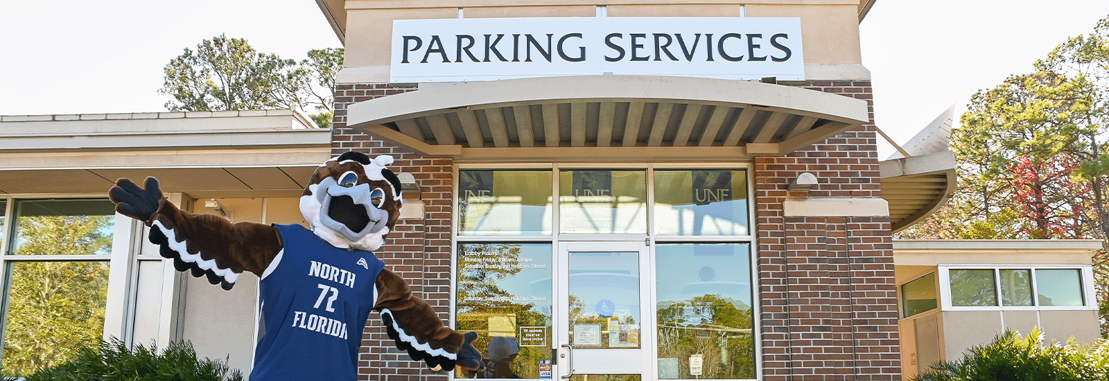 Ozzie standing in front of Parking Services building