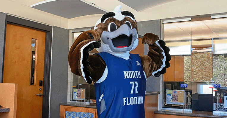 Ozzie mascot is flexing their arms inside the Parking Services building but this has been sized for mobile phone viewing