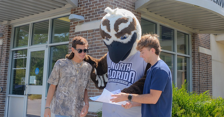 Ozzie and two students are looking at a parking map