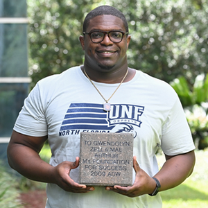 student holding a paver