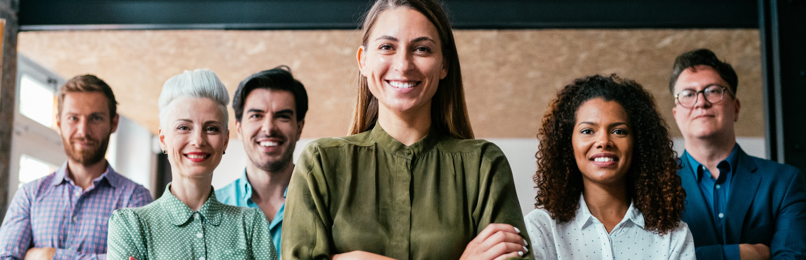 group of employees standing and smiling together