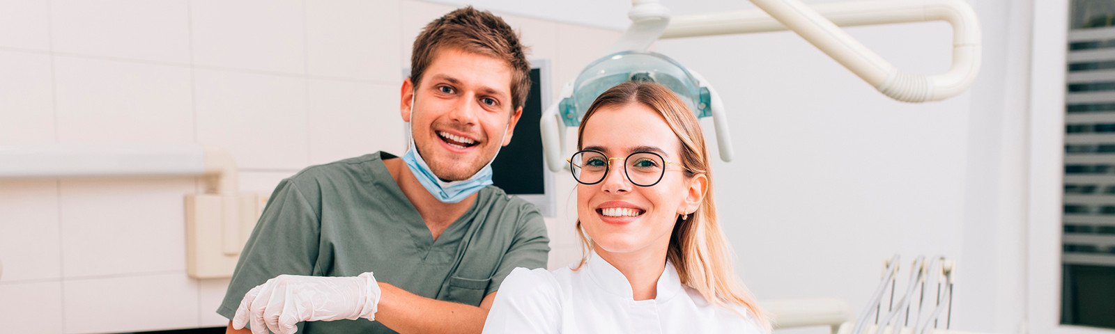 Dentist and dental assistant sitting in the exam room