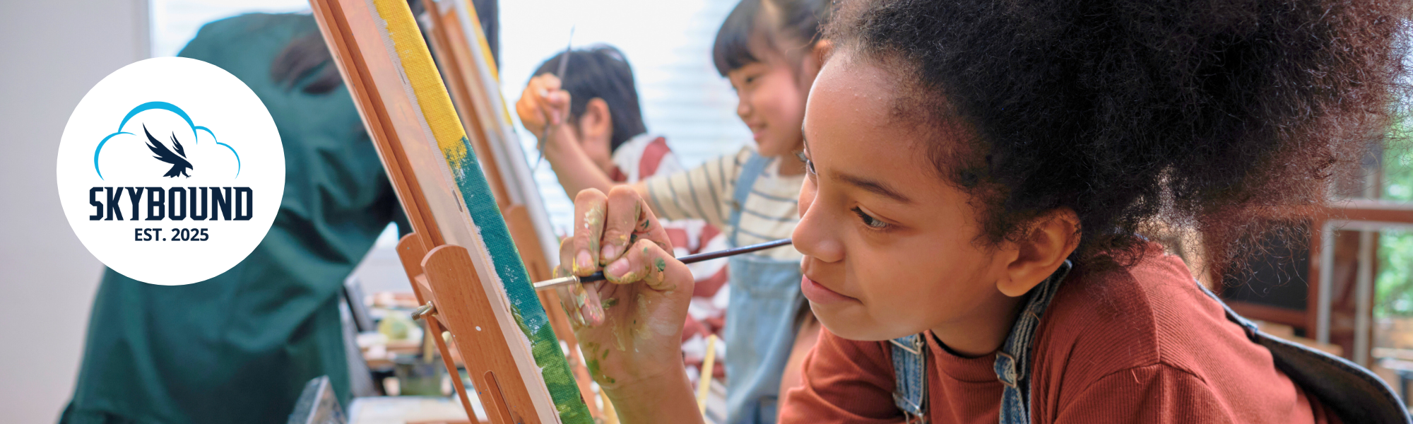 Young girl painting in a classroom