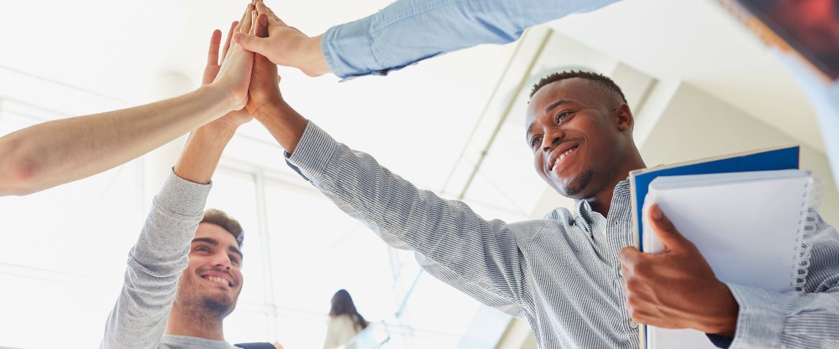 Happy and successful team having a high five