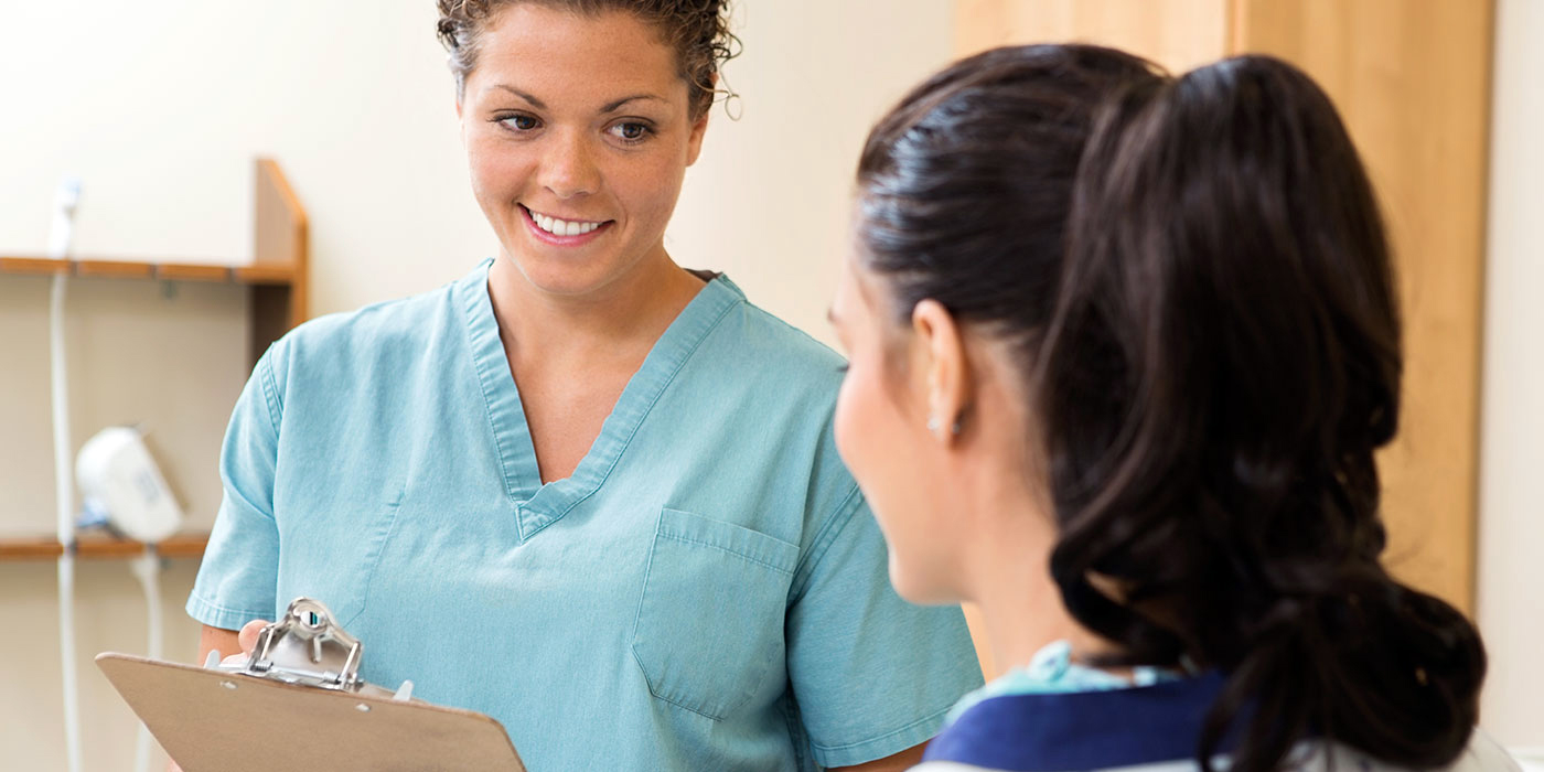 Medical assistant talking to a patient
