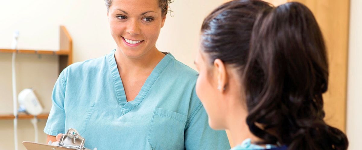 Medical assistant talking to a patient