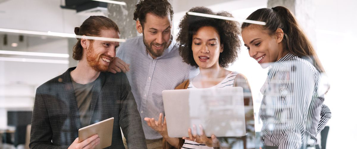 Group of developers looking at a laptop