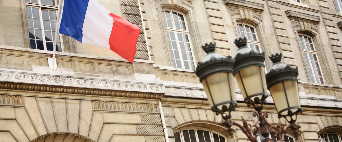 French flag and historical building