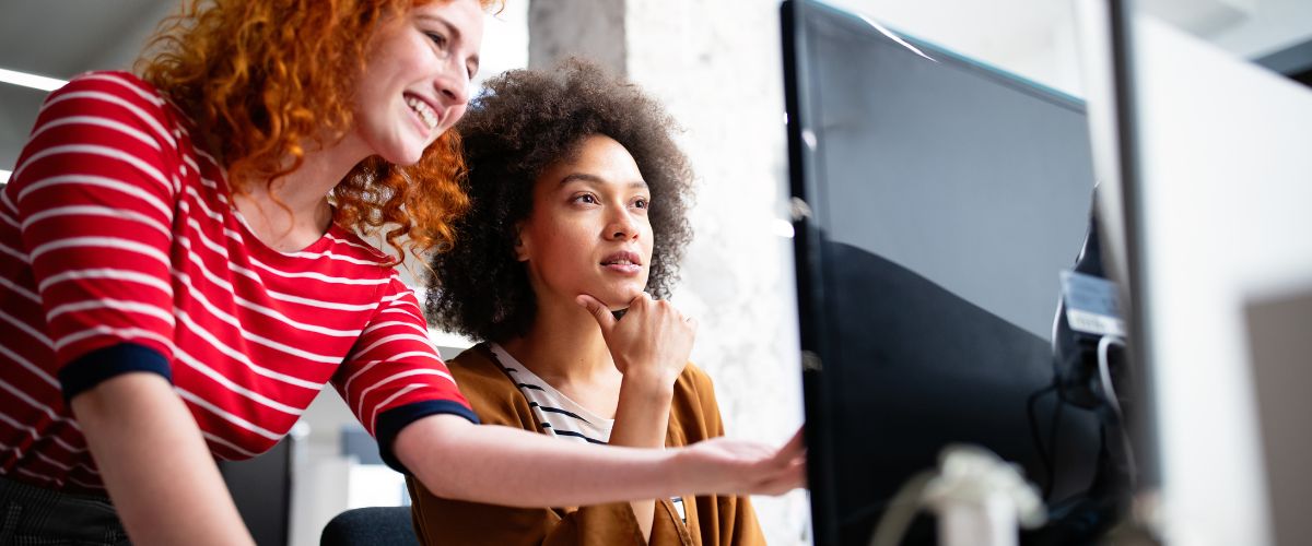 IT technician helping another woman