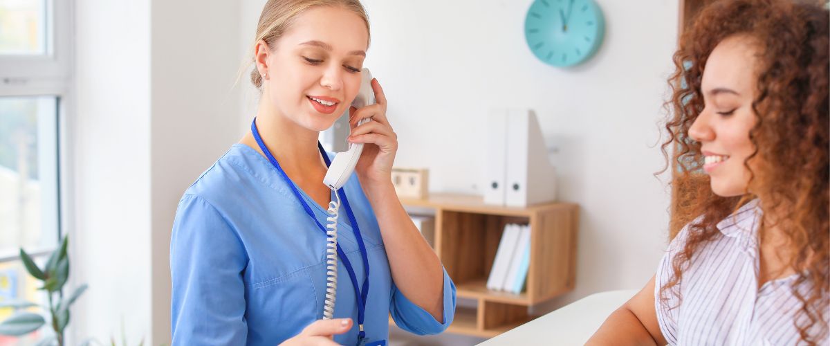 Medical receptionist answering a phone