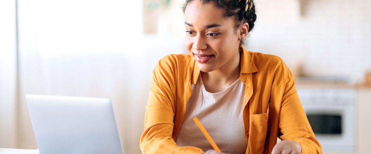 Woman with yellow shirt learning online