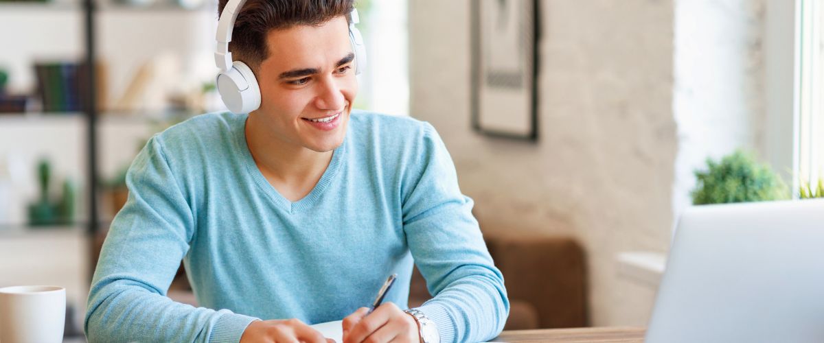 Young man with blue sweater learning online