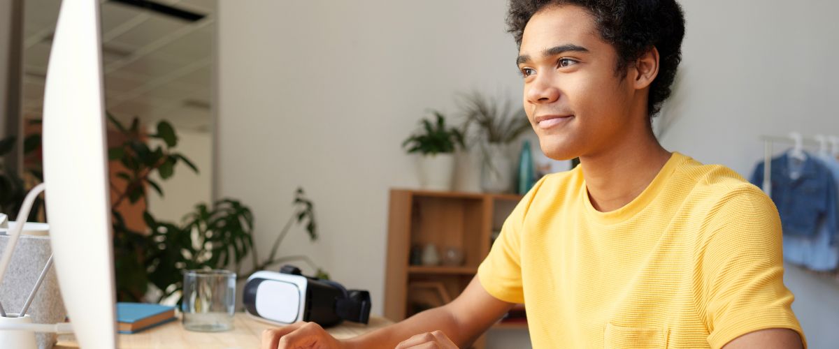 Young man with yellow t-shirt studying online