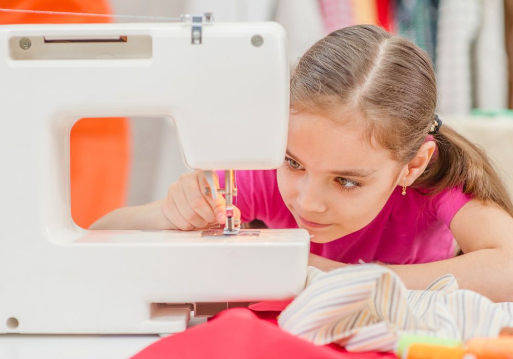 Girl threading a sewing machine