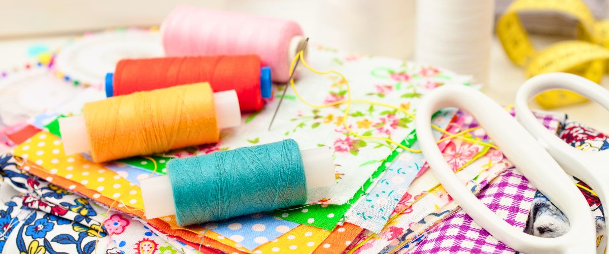 Colorful sewing threads on bright colored fabrics