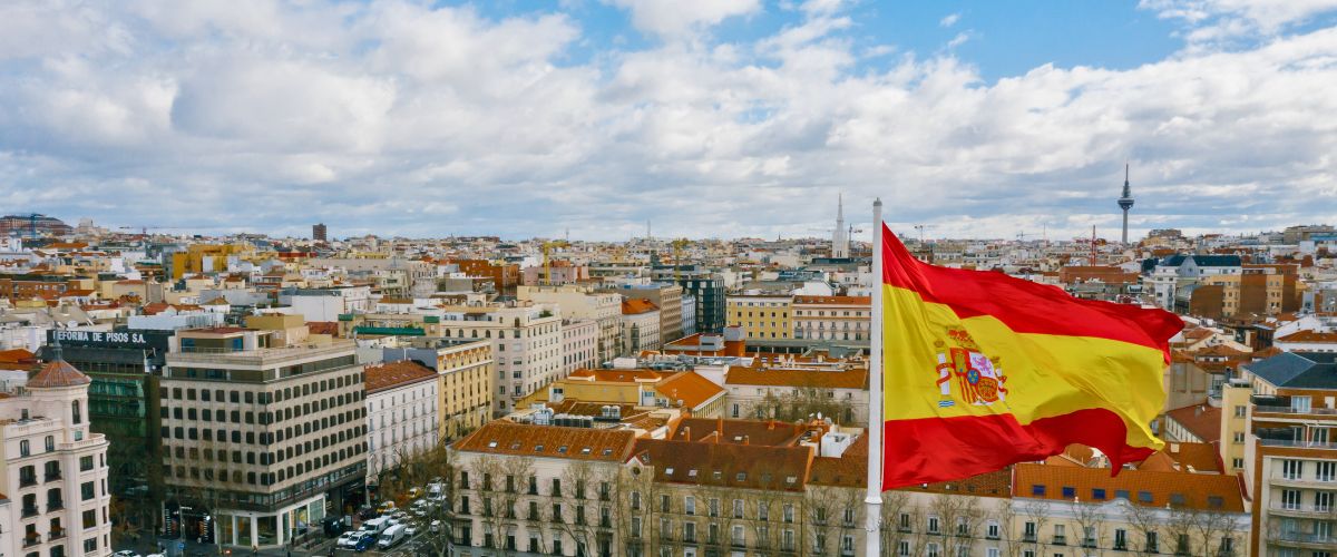 Spanish flag against cityscape