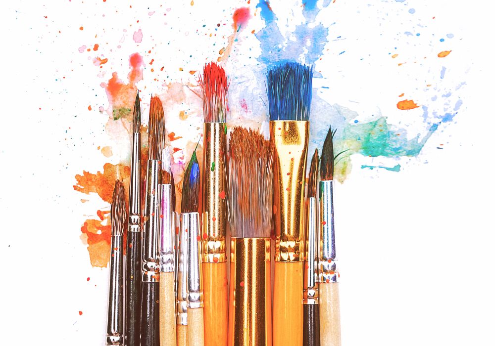Different sizes of paintbrushes and paint splashes