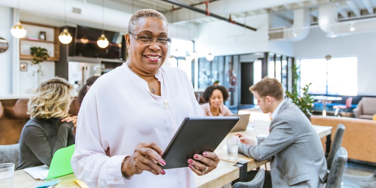 Smiling woman with a tablet in office