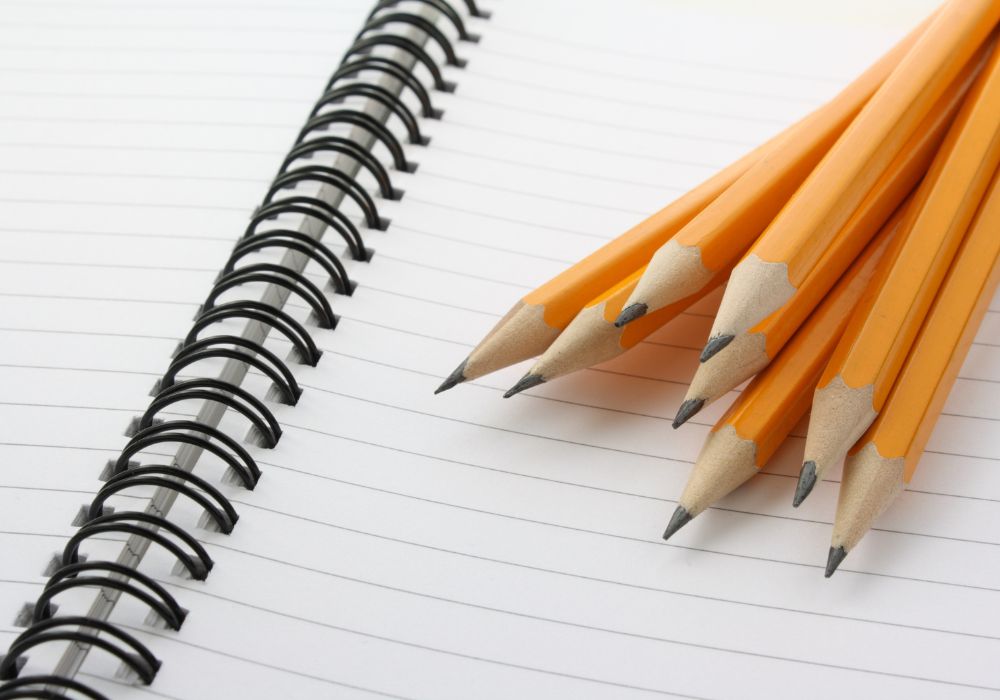 Yellow pencils and a blank notebook
