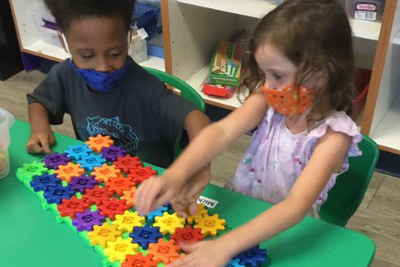 Students playing with colorful computing toys