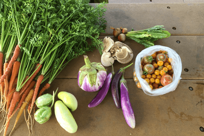 Carrots, cabbage, and other colorful veggies on a table