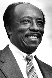 A smiling black and white side profile headshot of interim president Robinson.