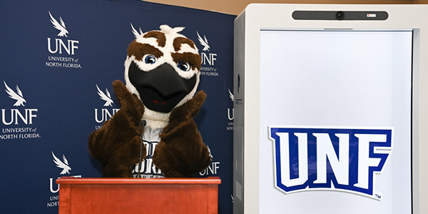 Ozzie Osprey standing at a podium