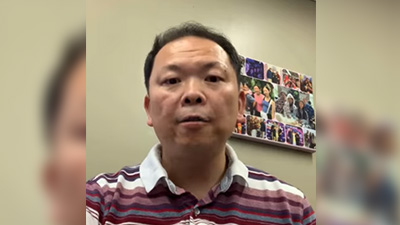 computing professor speaking to his camera phone