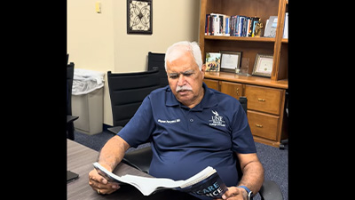 health admin professor reading a book