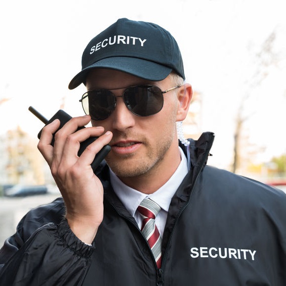 Security man speaking into a walkie
