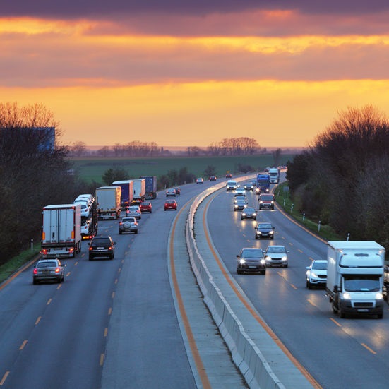 vehicles on a freeway at sunset