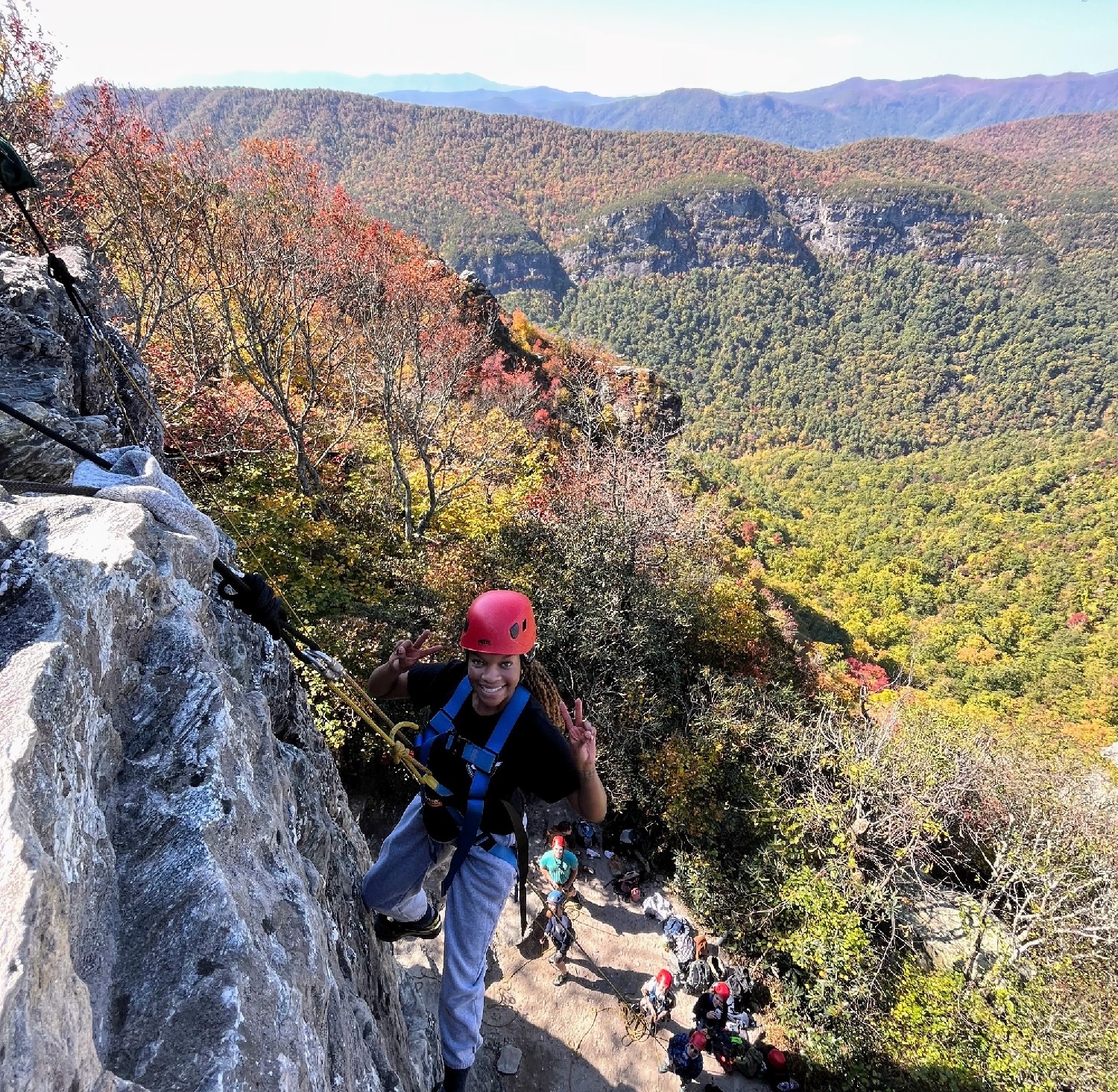student rock climbing
