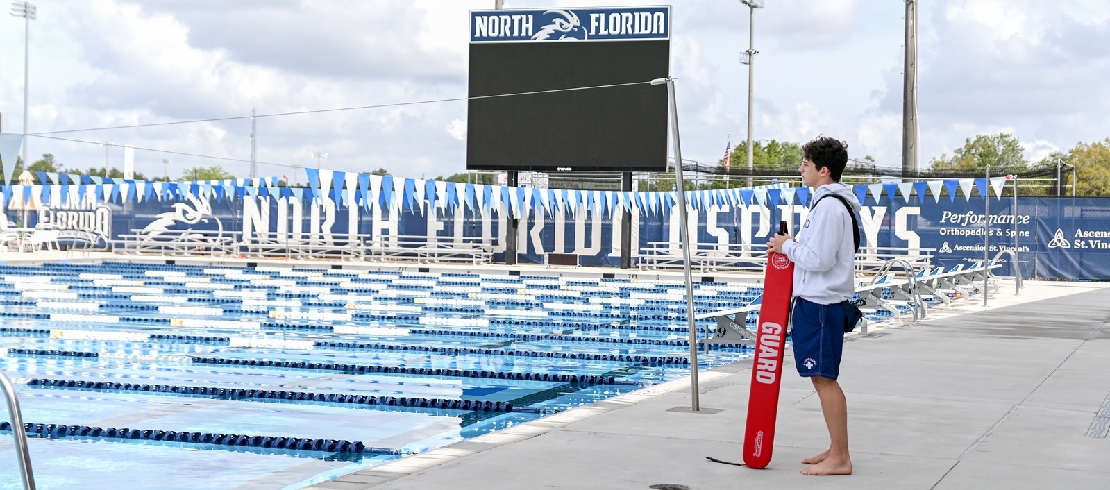 lifeguard standing by pool