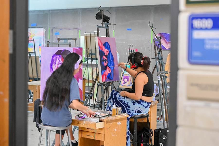 Art students painting in a classroom