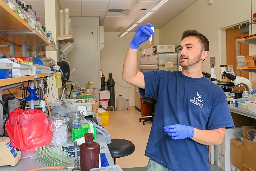 Student holding up a beaker in a lab