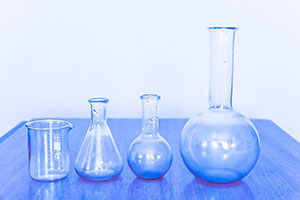 science lab with four glass containers