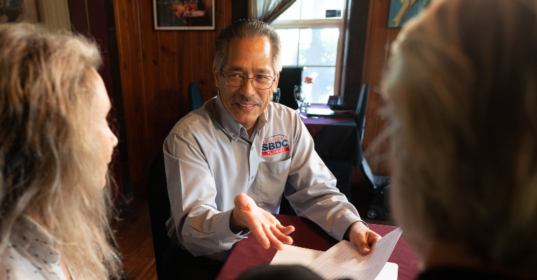 Business consultant with clients at a table