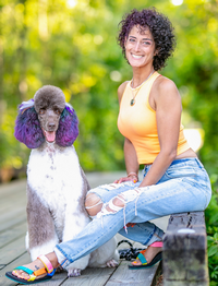 Nimsay Rivera with a dog sitting on a bench