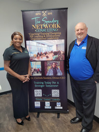 two people standing in front of banner for business services
