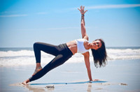 person in yoga pose on beach