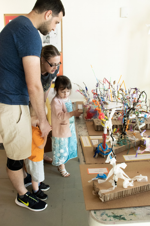 UNF Preschooler and parents looking at art sculptures