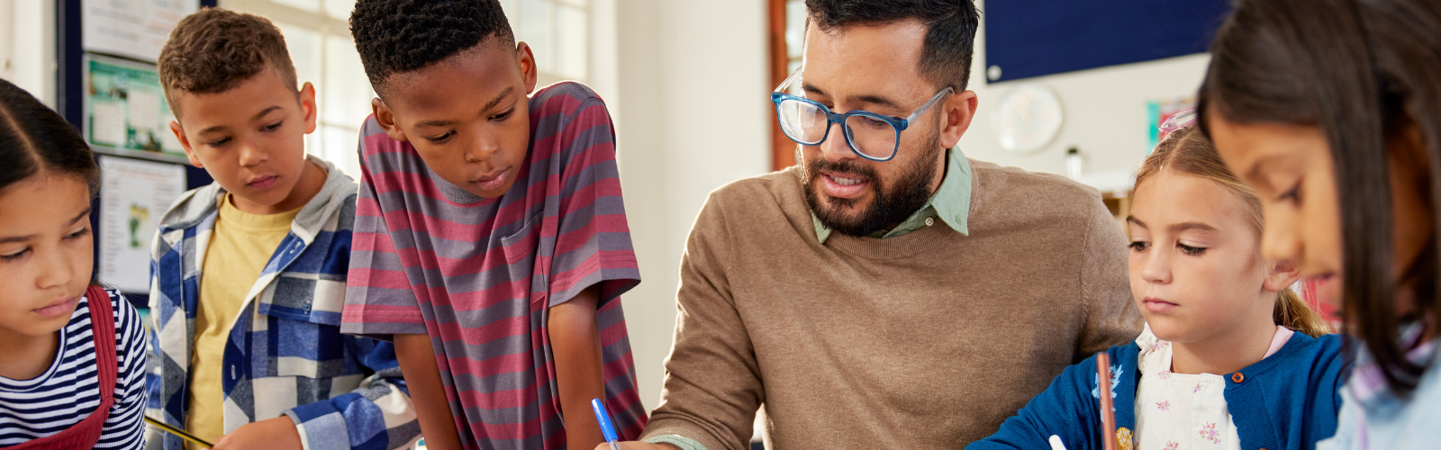 Male teacher leading a lesson with students in a classroom