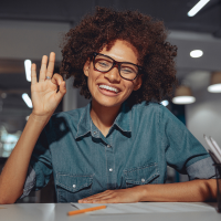 Women making an ok sign and smiling