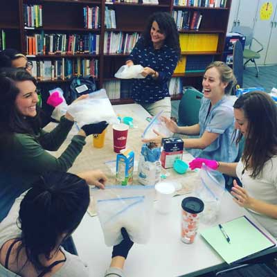 Grad students in class all sitting at a table together