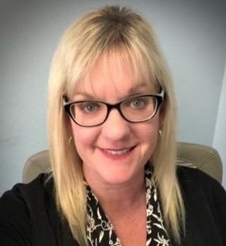 Headshot of Dr. Debbie Reed wearing glasses