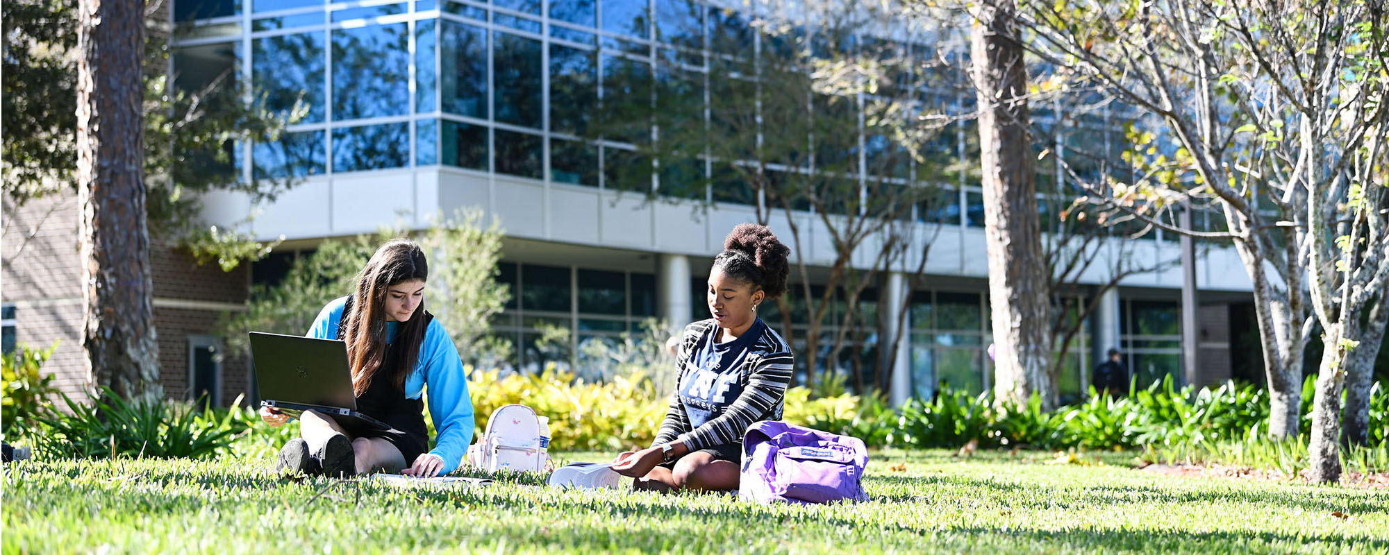 two students studying outside of Petway Hall